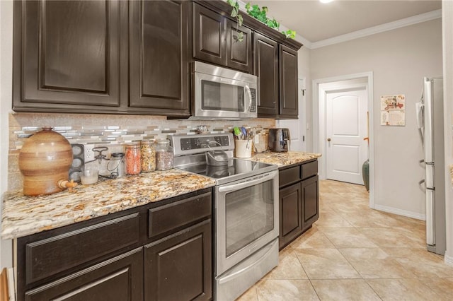 kitchen with dark brown cabinetry, crown molding, light tile patterned floors, stainless steel appliances, and backsplash