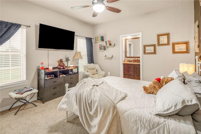 carpeted bedroom featuring connected bathroom and ceiling fan