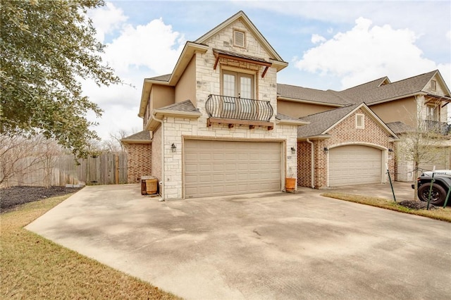 view of front of house featuring a garage and a balcony