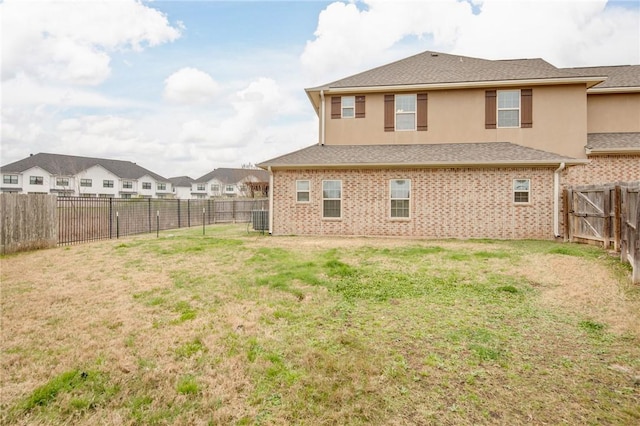 rear view of house with a lawn