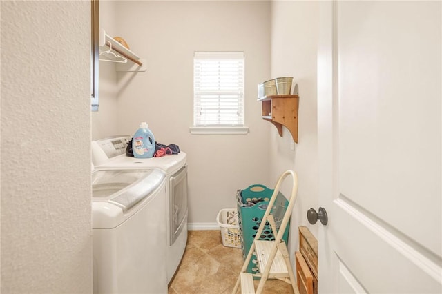 washroom with washing machine and dryer and light tile patterned floors