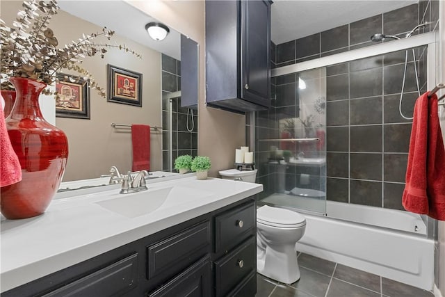 bathroom with washtub / shower combination, tile patterned flooring, vanity, and toilet