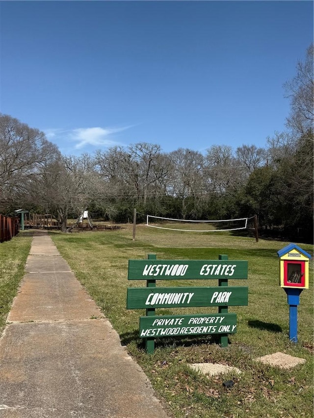 surrounding community with volleyball court and a yard