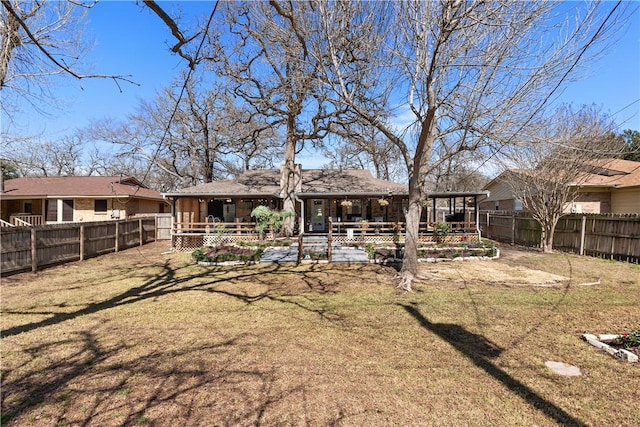 rear view of house with a yard, a patio area, and a fenced backyard