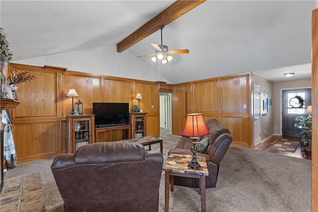 living area with carpet floors, a fireplace, vaulted ceiling with beams, and a ceiling fan