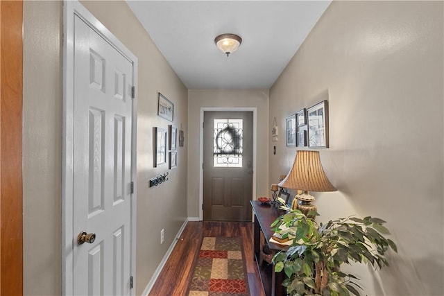 entryway with dark wood-style floors and baseboards