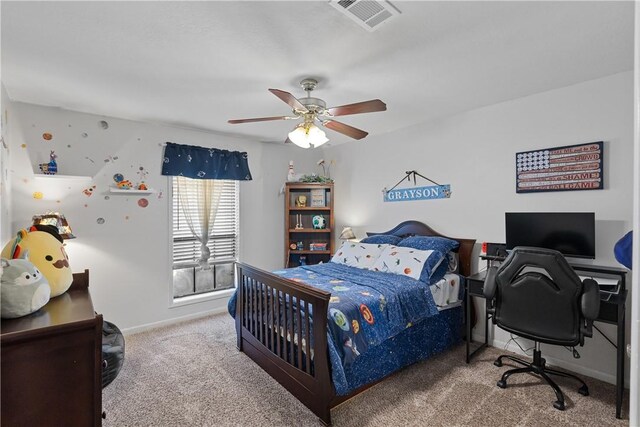 carpeted bedroom with baseboards, visible vents, and a ceiling fan