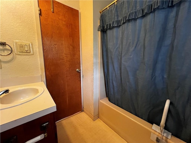 bathroom featuring vanity and shower / tub combo with curtain