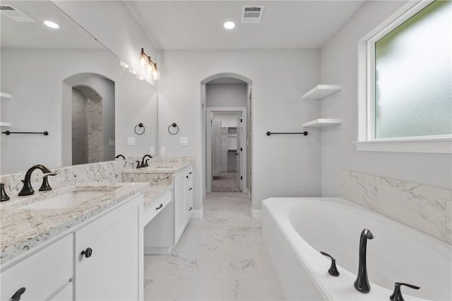 2906 Spector Dr, Bryan, TX 77808 - full bath featuring visible vents, vanity, a garden tub, and marble finish floor