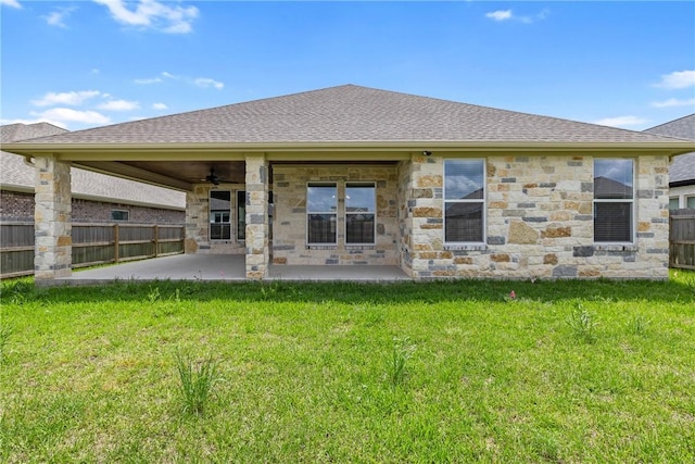 2906 Spector Dr, Bryan, TX 77808 - rear view of house featuring fence, stone siding, a patio area, a ceiling fan, and a lawn