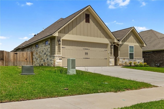 2906 Spector Dr, Bryan, TX 77808 - view of front of home featuring a garage, driveway, stone siding, board and batten siding, and fence