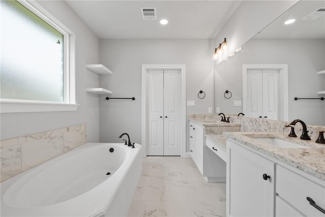 2906 Spector Dr, Bryan, TX 77808 - bathroom with visible vents, vanity, a bath, and marble finish floor