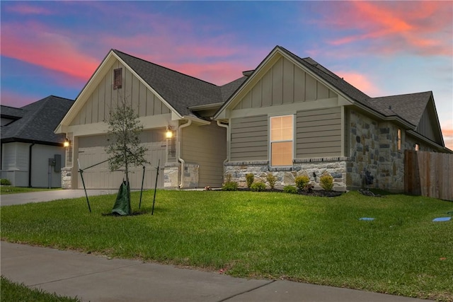 2906 Spector Dr, Bryan, TX 77808 - view of front of house with stone siding, board and batten siding, a yard, and a garage