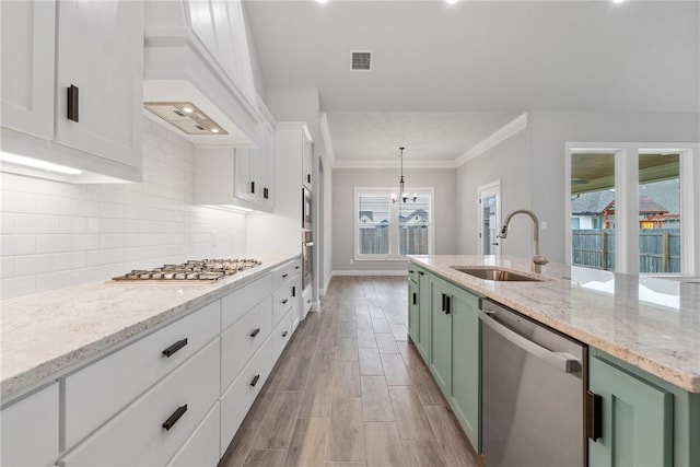 2906 Spector Dr, Bryan, TX 77808 - kitchen featuring green cabinetry, white cabinetry, a sink, visible vents, and stainless steel appliances