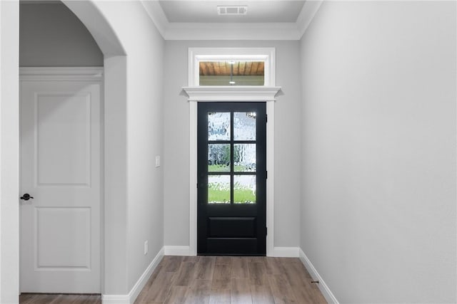 2906 Spector Dr, Bryan, TX 77808 - doorway with arched walkways, visible vents, wood finished floors, and baseboards