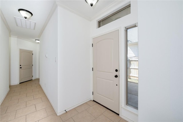 foyer entrance with light tile patterned flooring, visible vents, baseboards, and ornamental molding