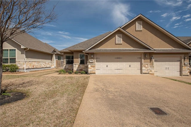 view of front of house with concrete driveway, an attached garage, stone siding, and stucco siding