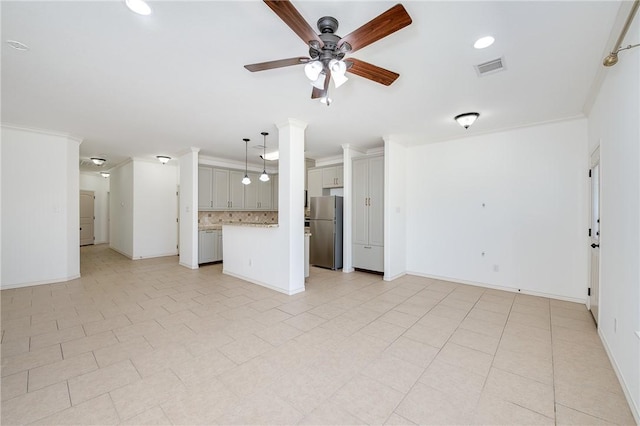 unfurnished living room with visible vents, baseboards, ceiling fan, and ornamental molding