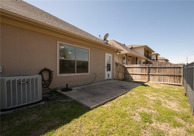 view of yard with a patio area, central AC, and fence