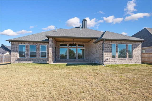 rear view of house featuring a lawn