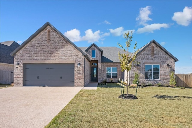 view of front of home featuring a garage and a front yard