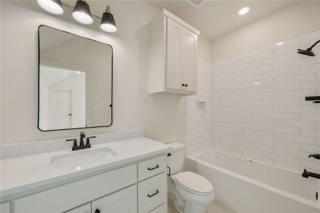 full bathroom featuring tiled shower / bath combo, vanity, and toilet