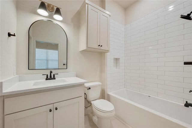 full bathroom with vanity, tiled shower / bath, and toilet