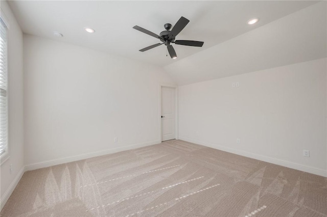 carpeted empty room with lofted ceiling and ceiling fan