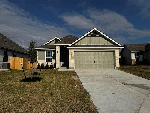 craftsman-style home featuring a garage, central air condition unit, and a front yard