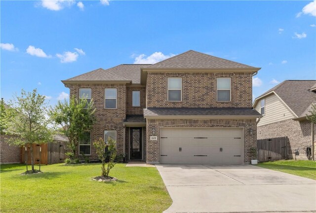 2609 Kimbolton Dr, College Station, TX 77845 - view of front facade with brick siding, concrete driveway, and an attached garage