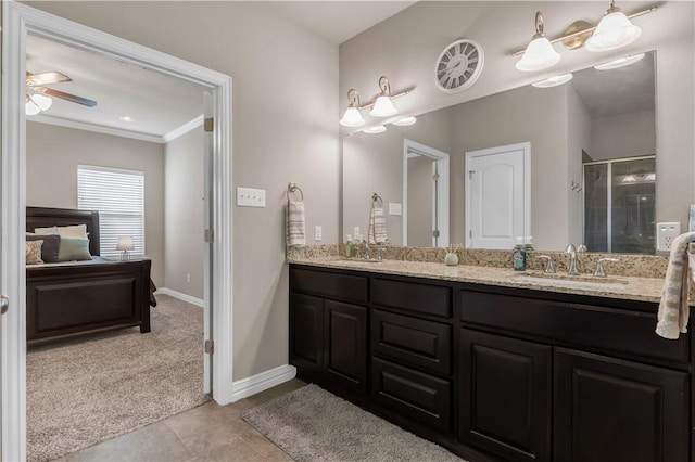 2609 Kimbolton Dr, College Station, TX 77845 - bathroom featuring double vanity, a shower stall, crown molding, ceiling fan, and baseboards