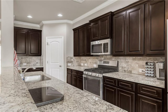 2609 Kimbolton Dr, College Station, TX 77845 - kitchen featuring stainless steel appliances, a sink, crown molding, dark brown cabinets, and light stone countertops