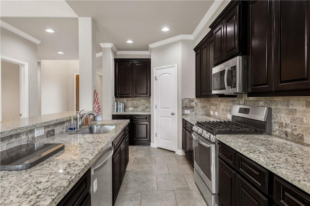 2609 Kimbolton Dr, College Station, TX 77845 - kitchen with stainless steel appliances, a sink, light stone counters, ornamental molding, and backsplash