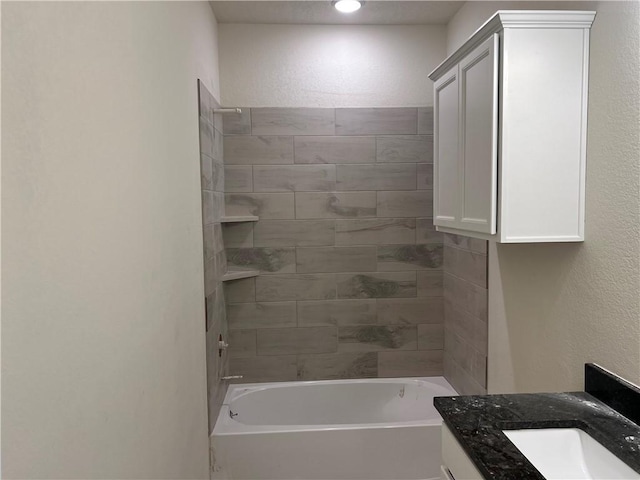 bathroom with vanity and tiled shower / bath combo