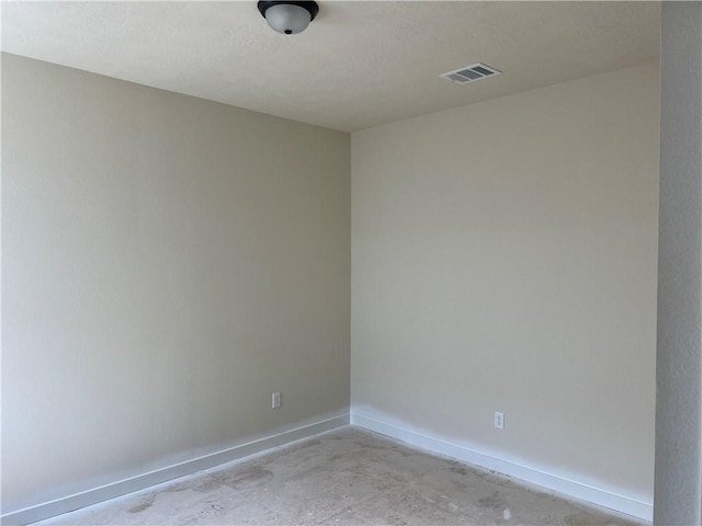 spare room with a textured ceiling