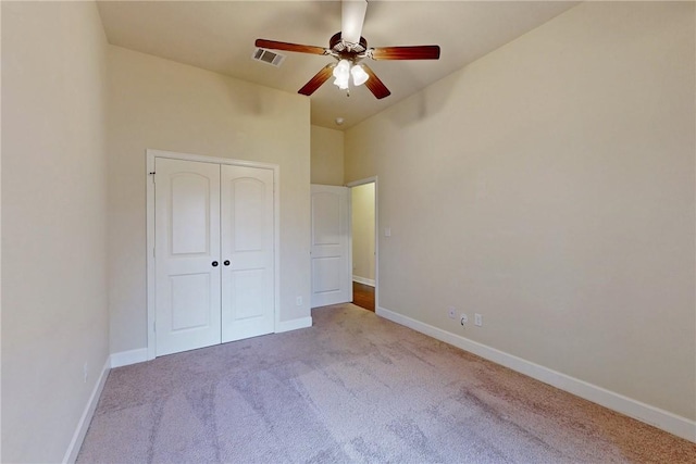 unfurnished bedroom featuring carpet, baseboards, visible vents, and a closet