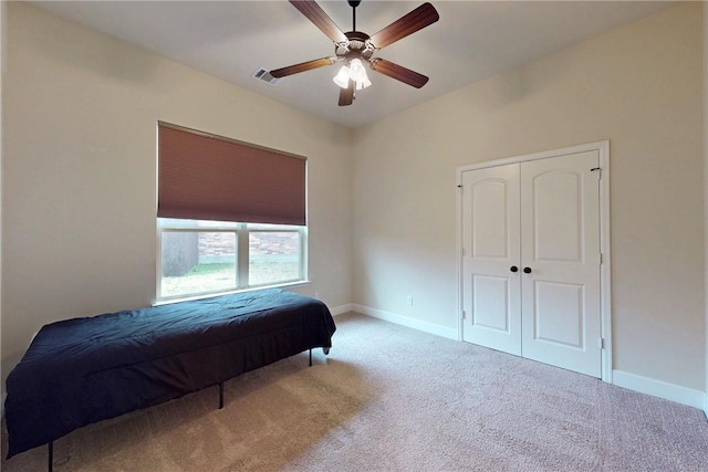 bedroom featuring a ceiling fan, carpet flooring, visible vents, and baseboards