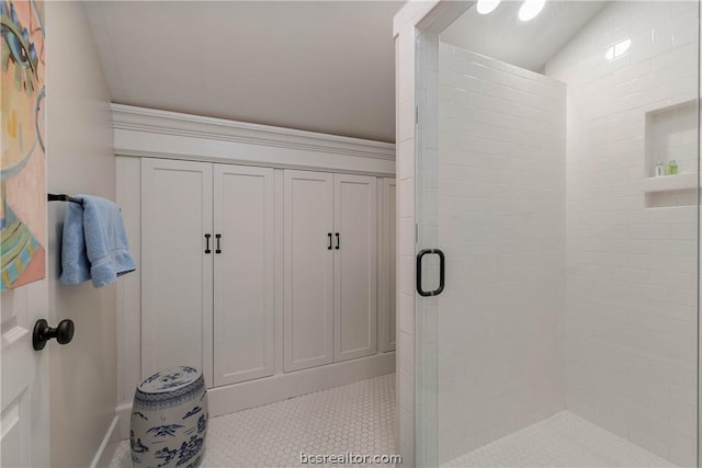 bathroom featuring vaulted ceiling and walk in shower