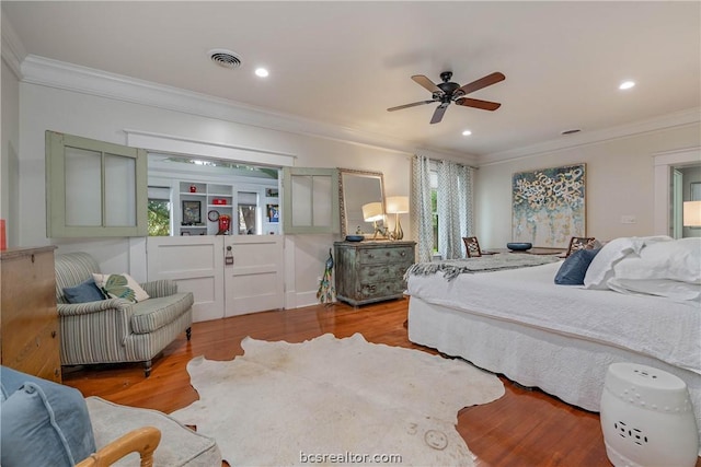 bedroom with ceiling fan, light wood-type flooring, and crown molding