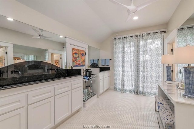 bathroom featuring ceiling fan and vaulted ceiling