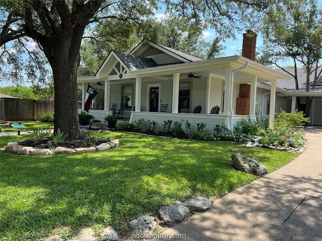 view of front of property with covered porch and a front yard