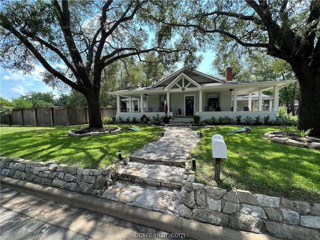 view of front of home with covered porch and a front yard