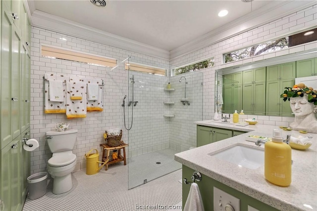 bathroom featuring tiled shower, toilet, vanity, tile walls, and ornamental molding