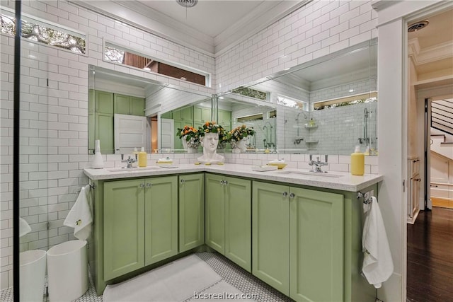 bathroom featuring hardwood / wood-style flooring, an enclosed shower, ornamental molding, and tile walls