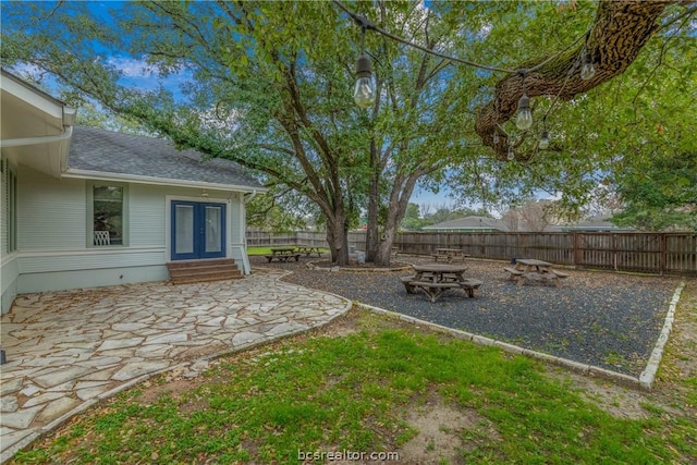 view of yard featuring a patio area and french doors