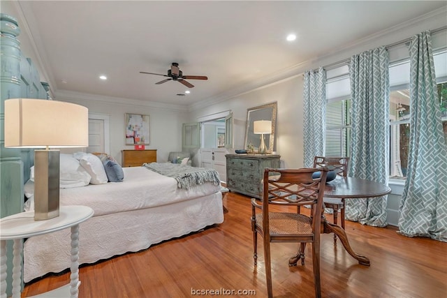 bedroom featuring ceiling fan, hardwood / wood-style floors, and crown molding