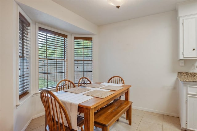 3300 Dallis Dr, College Station, TX 77845 - dining space with baseboards and light tile patterned floors