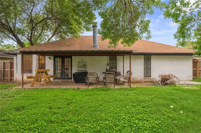 3300 Dallis Dr, College Station, TX 77845 - back of property featuring french doors, a patio area, a shingled roof, and brick siding