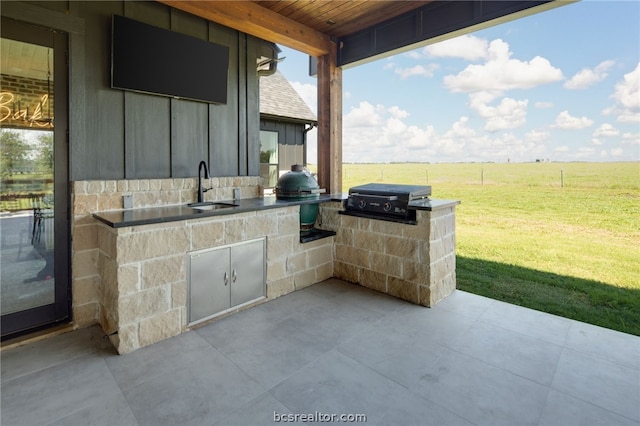 view of patio with an outdoor kitchen, a grill, and sink