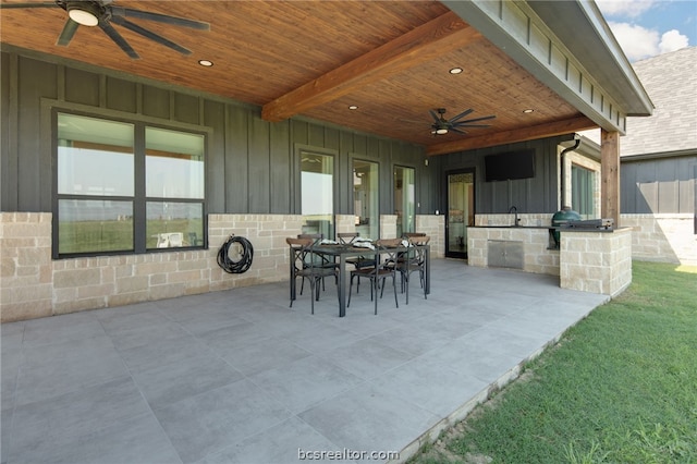 view of patio featuring ceiling fan and exterior kitchen